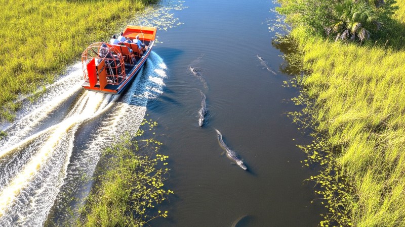 a group of people riding bikes down a river